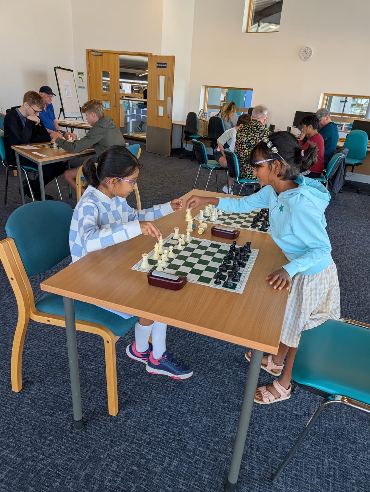Sarah and Arini playing chess