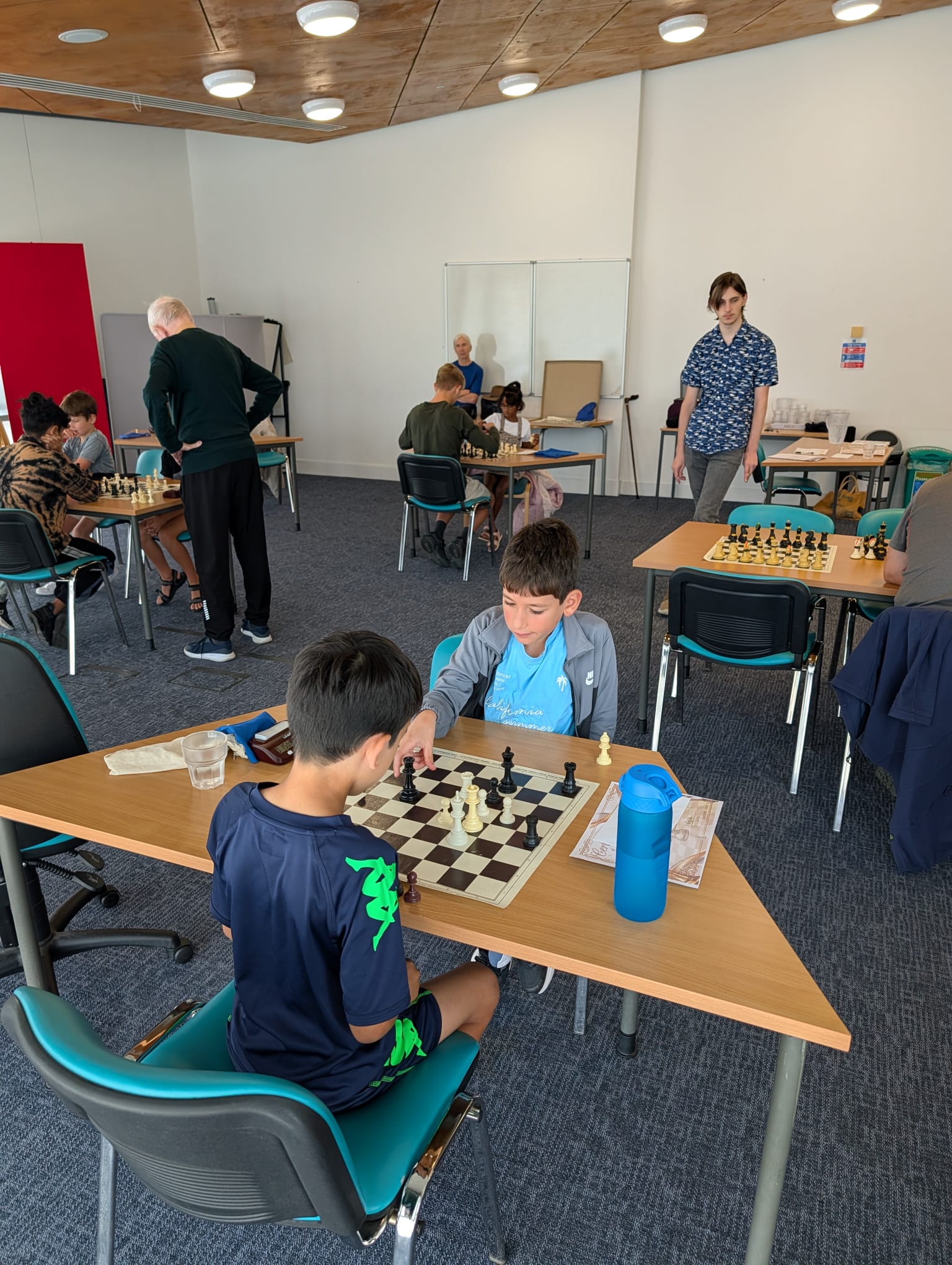 Games underway around the room with coaches on hand