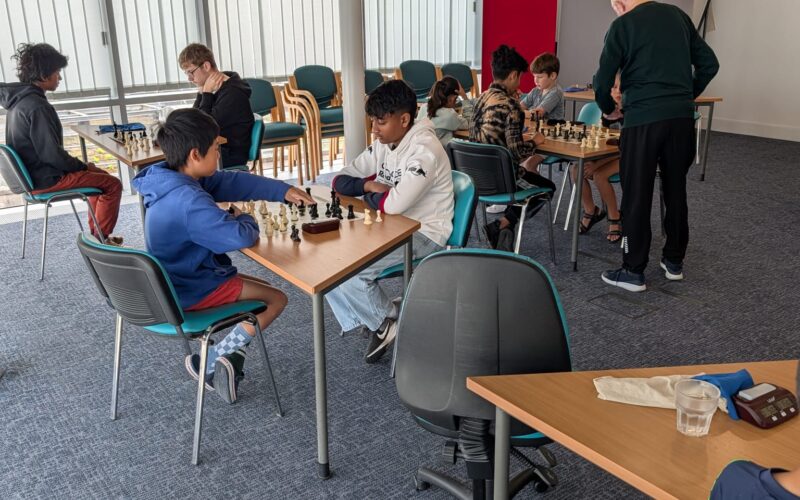Juniors playing games across several boards in the first session