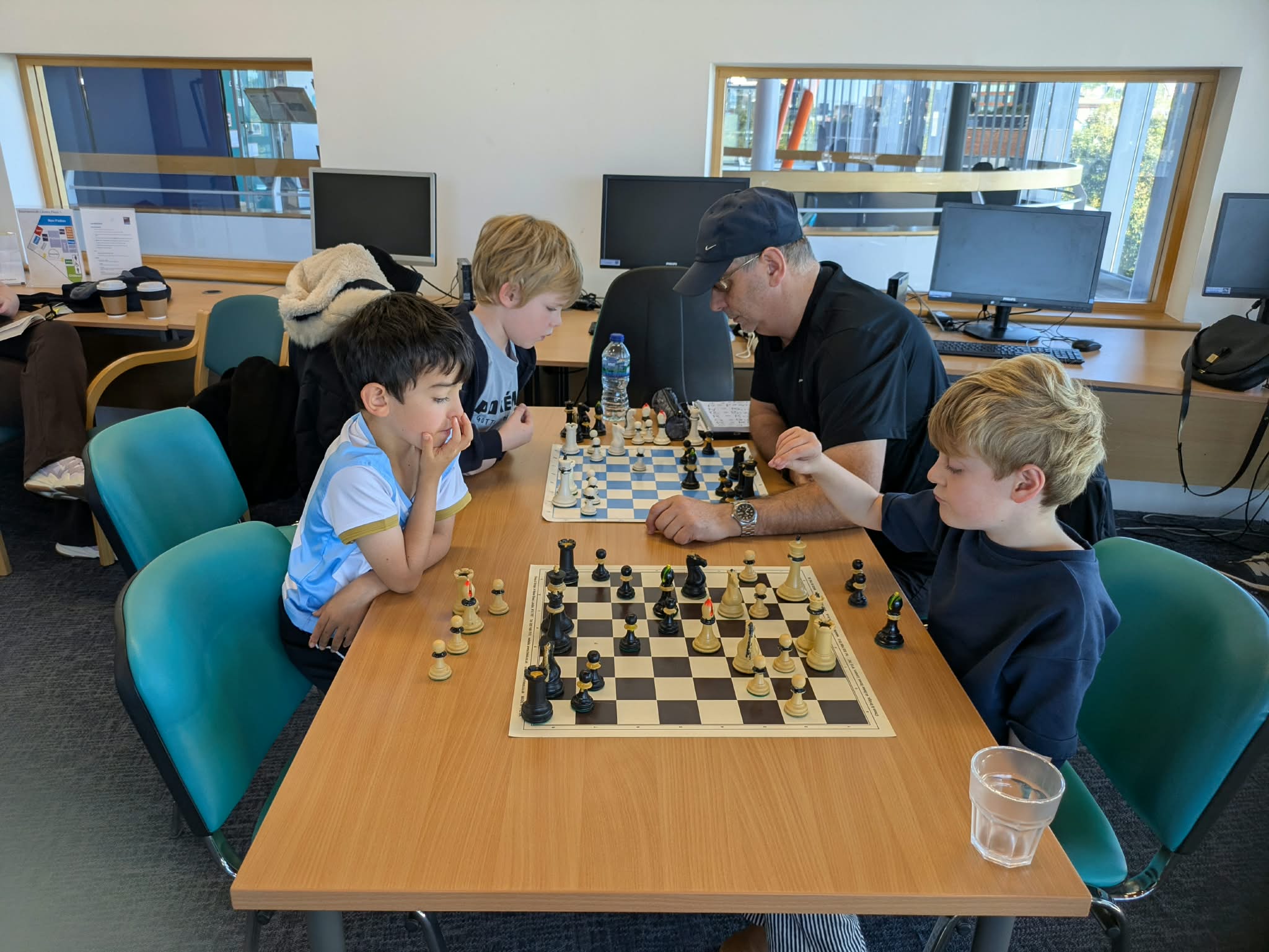 Coach working with young players at the board