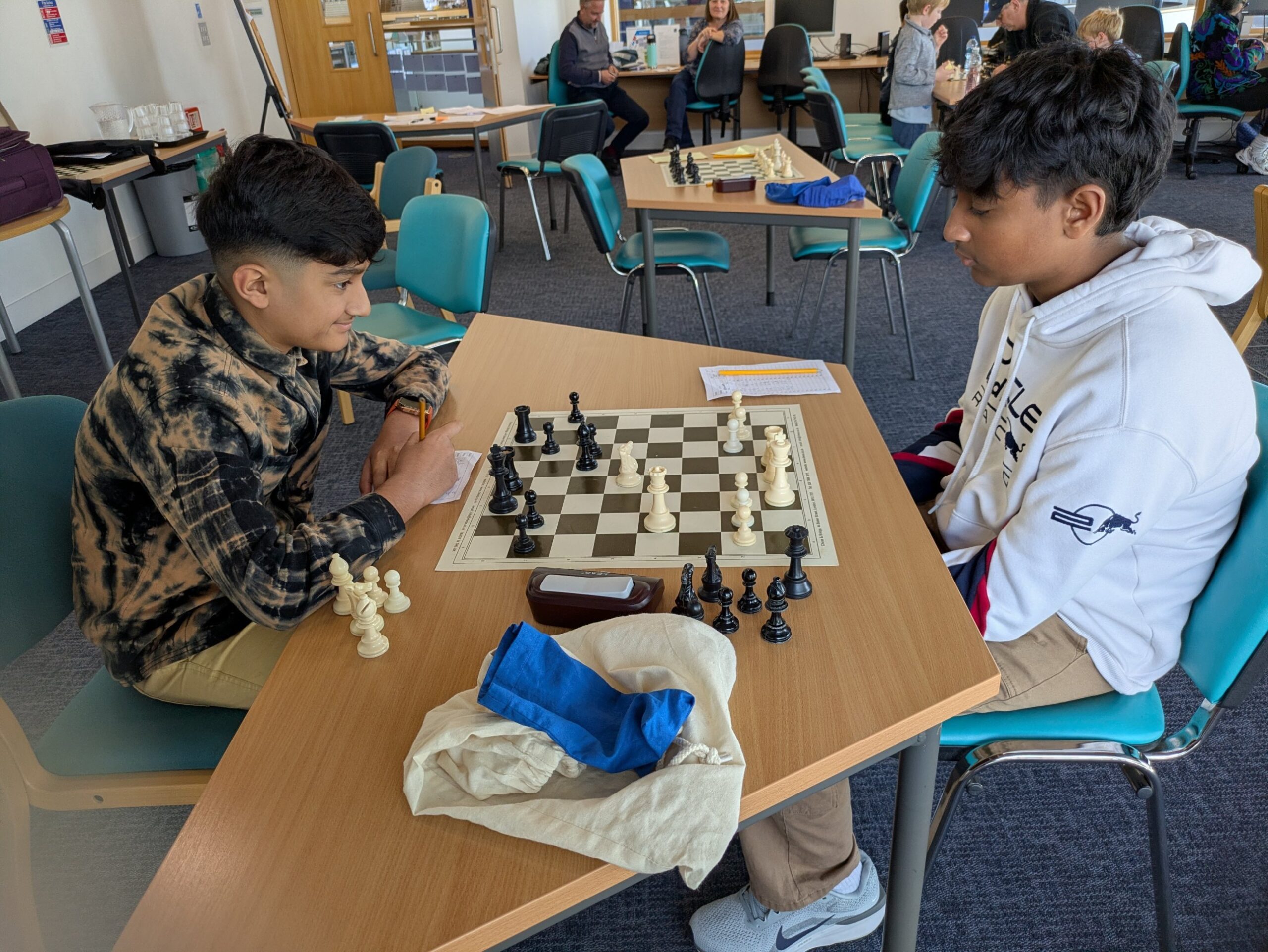 Two players facing each other at the board