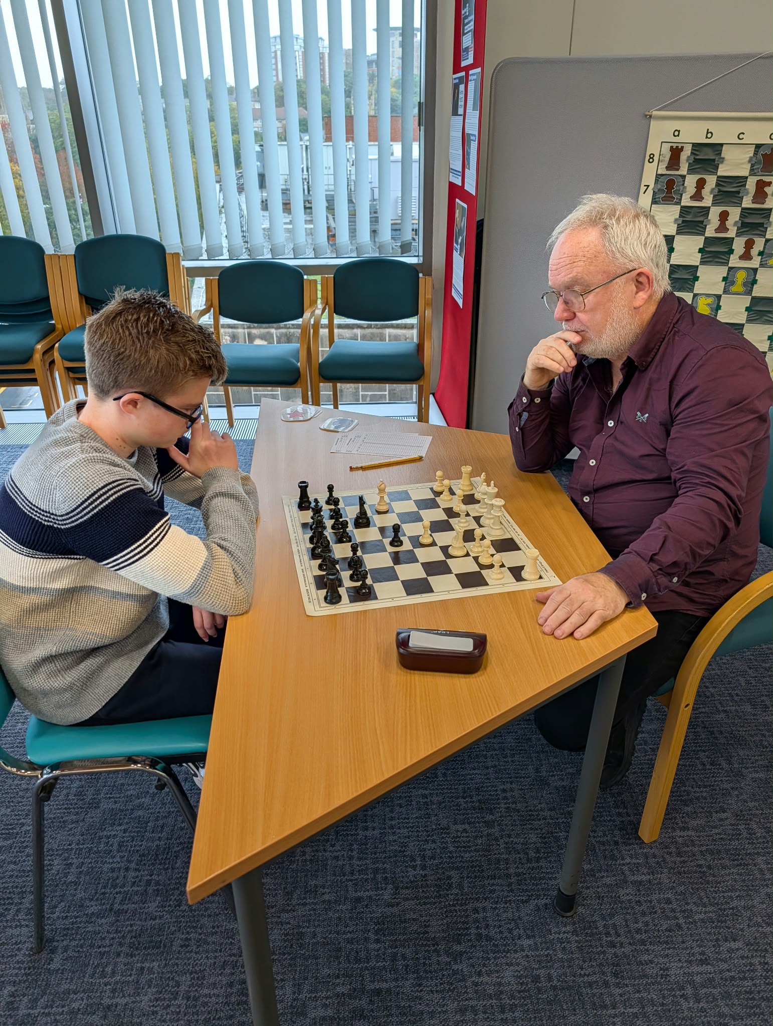 A young player in a focused game against one of the coaches
